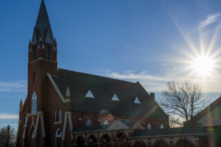 Wide angle exterior view of Holy Trinity Catholic Church in Okarche Oklahoma.