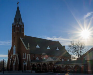 Wide angle exterior view of Holy Trinity Catholic Church in Okarche Oklahoma.