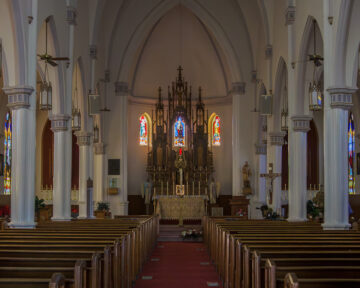 Interior view of the nave and seating at Holy Trinity Catholic Church in Okarche Oklahoma.