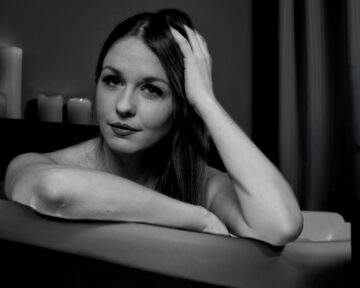 Artistic studio portrait of Kate with a bathtub prop in a conceptual photography session