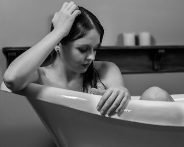 Artistic studio portrait of Kate in a vintage bathtub conceptual photography