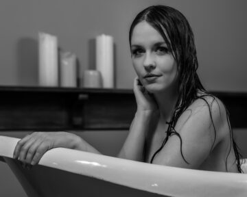 Artistic studio portrait of Kate with a vintage bathtub prop and creative lighting