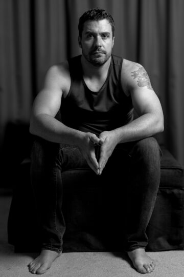 Dramatic black and white portrait of Mark with high contrast lighting and professional studio composition