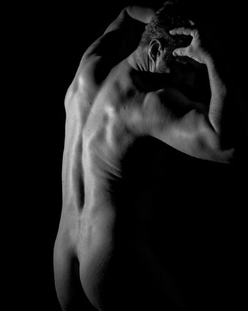Artistic black and white studio portrait of Mark with dramatic lighting and high contrast shadows